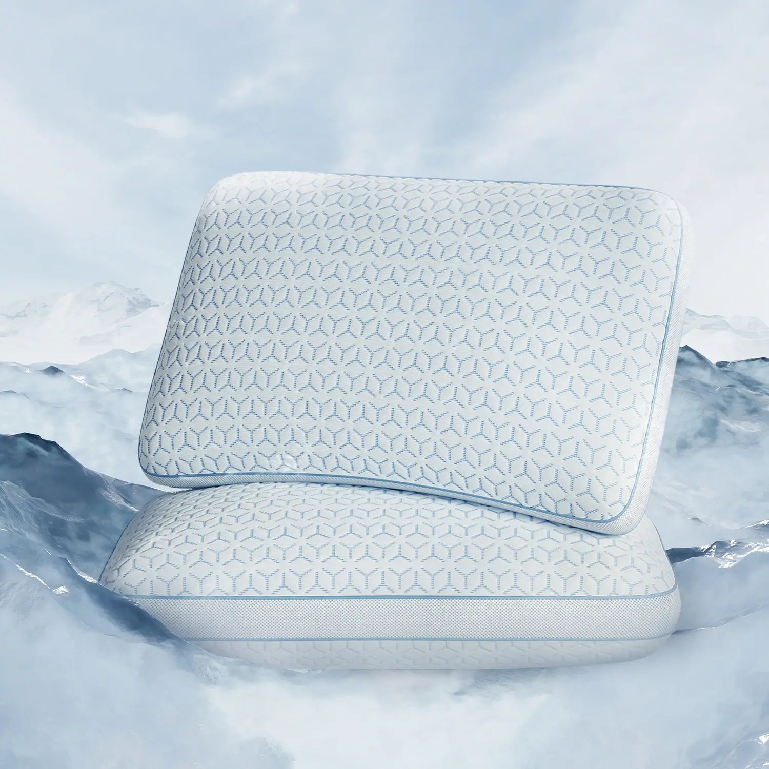 Two white pillows with a geometric pattern on a snowy mountain background