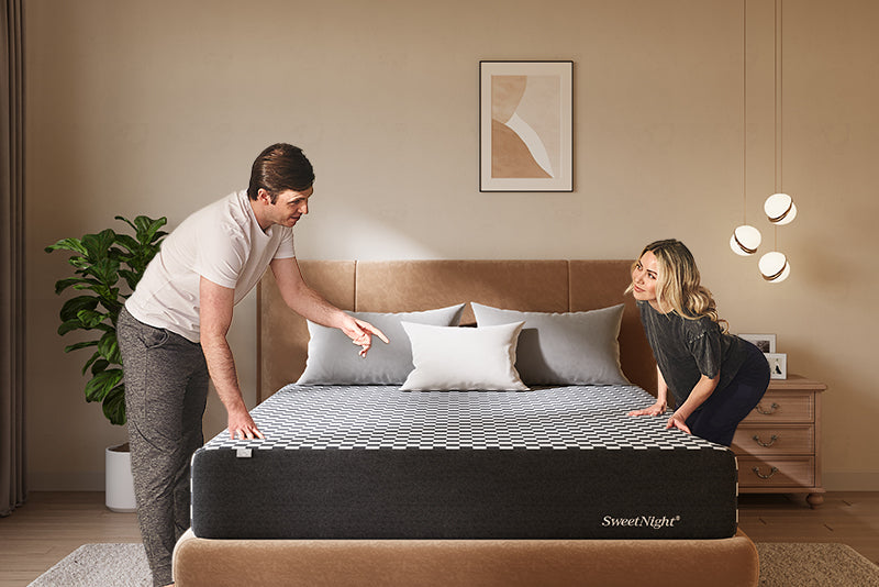 Couple interacting with Prime Memory Foam Mattress in a modern bedroom setting, showcasing its comfort and support features.
