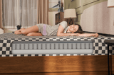 A women softly sleeping on sweetnight prime memory foam mattress