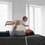 Mother playing with baby on the Best Cooling Mattress, showcasing comfort and fun for hot sleepers.