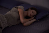 A woman enjoys deep, peaceful sleep on a comfortable mattress, a key benefit of the October mattress clearance deals.