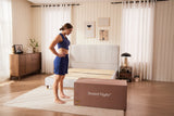 Woman looking at a SweetNight mattress box while preparing for better sleep quality and managing night sweats.