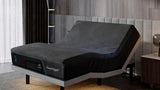 Adjustable bed with the head section raised in front of a wall-mounted upholstered headboard, with a nightstand beside the bed