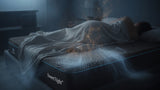 Sleeper resting on a cooling memory foam mattress as body heat is drawn away from the surface