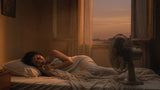 Person sleeping in a hot bedroom during a heatwave with a fan and an open window