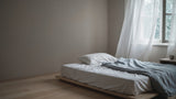Empty bed with duvet folded back in a cool morning bedroom, illustrating heat loss during sleep