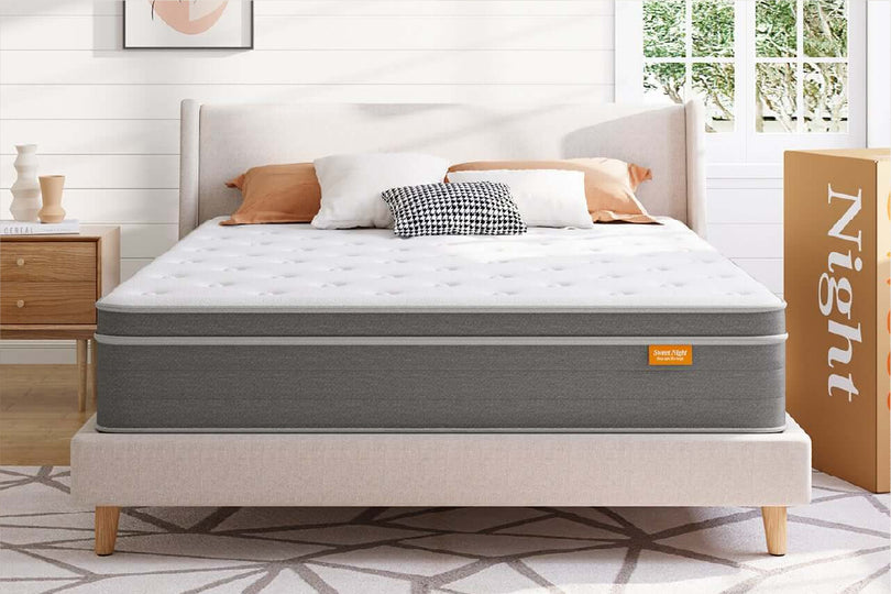 Sweet Night Island Hybrid Mattress with white quilted top and grey side panels on a bed, bedroom setting.